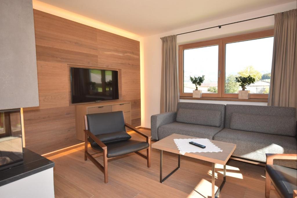 a living room with a couch and a table at Apartment Brandstätter 1 & 2 by Apartment Managers in Brixen im Thale