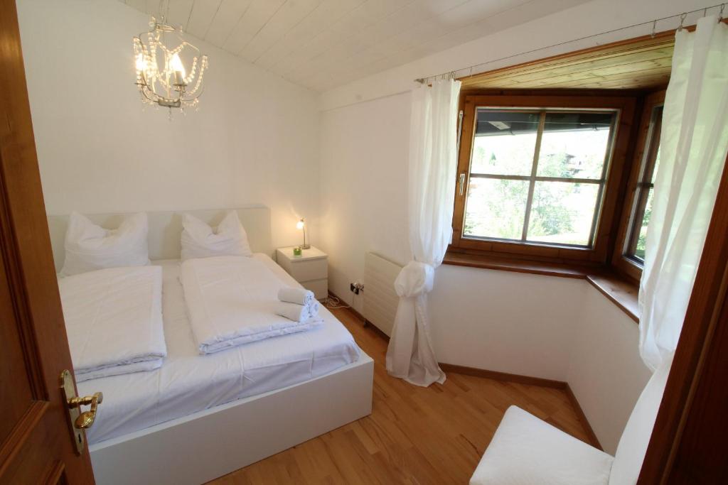 A bed or beds in a room at Chalet Gaisberg by Apartment Managers