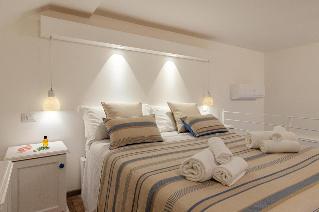 a bedroom with a large bed with towels on it at IL CORTILETTO in Porto Cesareo