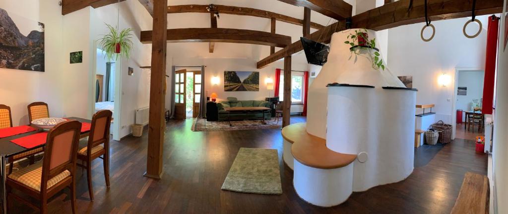 a living room with a dining room and a living room with a table at Köbelerhof - Stilvoll eingerichtete Landwohnung in Kördorf
