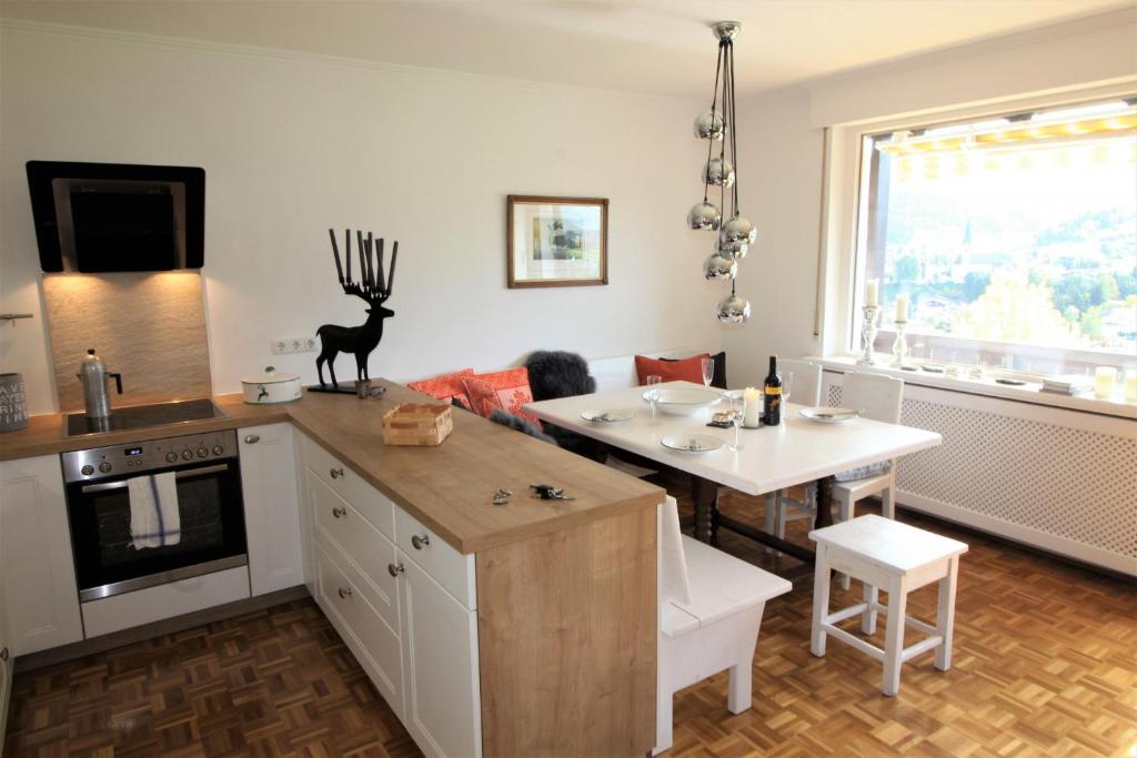 a kitchen with a table and a dining room at Apartment Weinberg by Apartment Managers in Kirchberg in Tirol