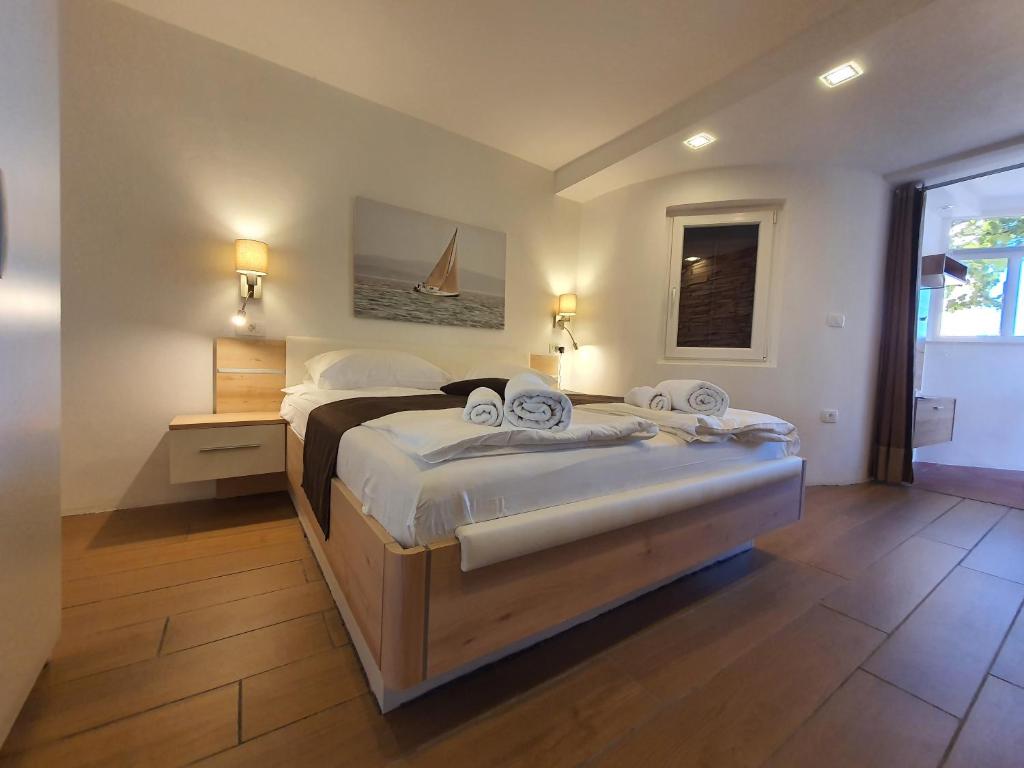 a bedroom with a large bed with white sheets at Apartma Kočevar Portorož in Portorož