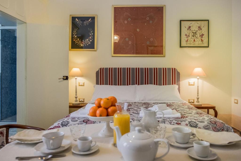 a bedroom with a bed with a table with fruit on it at Palazzo Bernardini Suites in Lecce