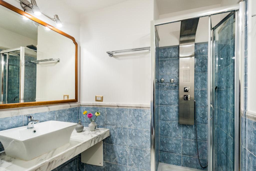 a bathroom with a sink and a shower at Palazzo Bernardini Suites in Lecce