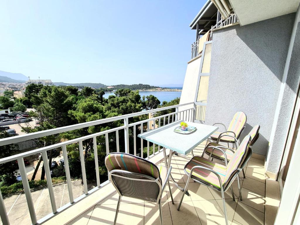 a balcony with a table and chairs on a building at Apartments Veronika in Makarska