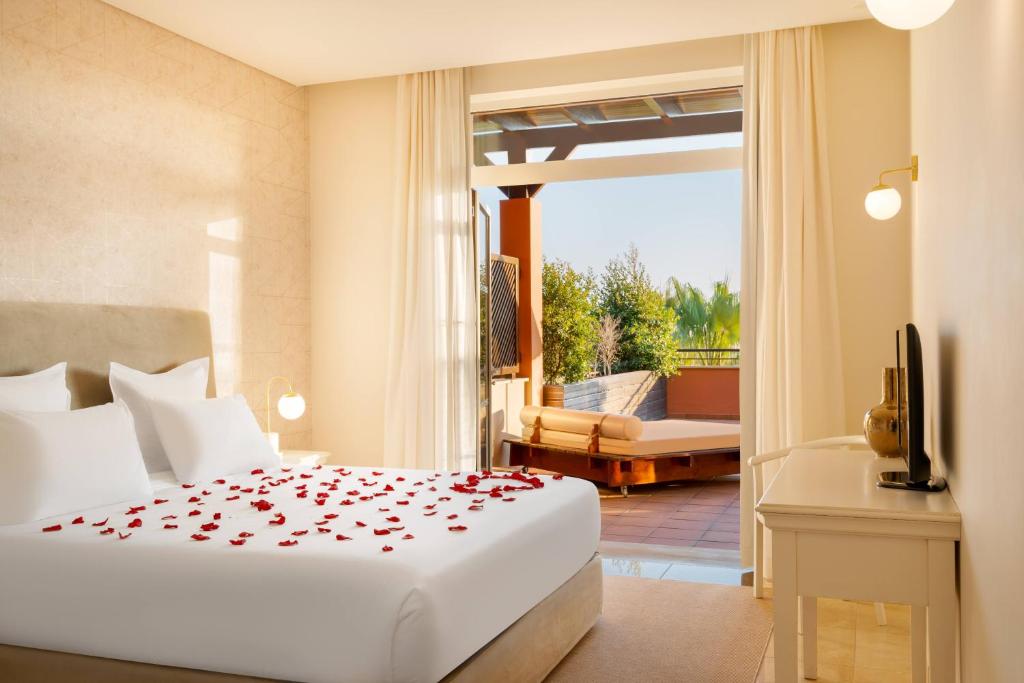 a bedroom with a bed and a balcony at Monte Santo Resort in Carvoeiro