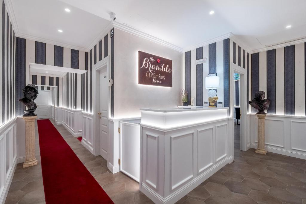 a hallway with a red carpet and a red rug at Bramble Luxury Suites in Rome