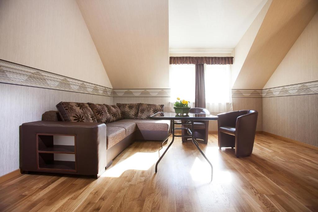 a living room with a couch and a table at Liepas in Ventspils