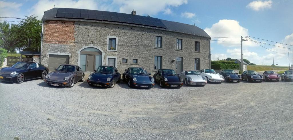 a group of cars parked in front of a building at Chez Peponne in Dinant