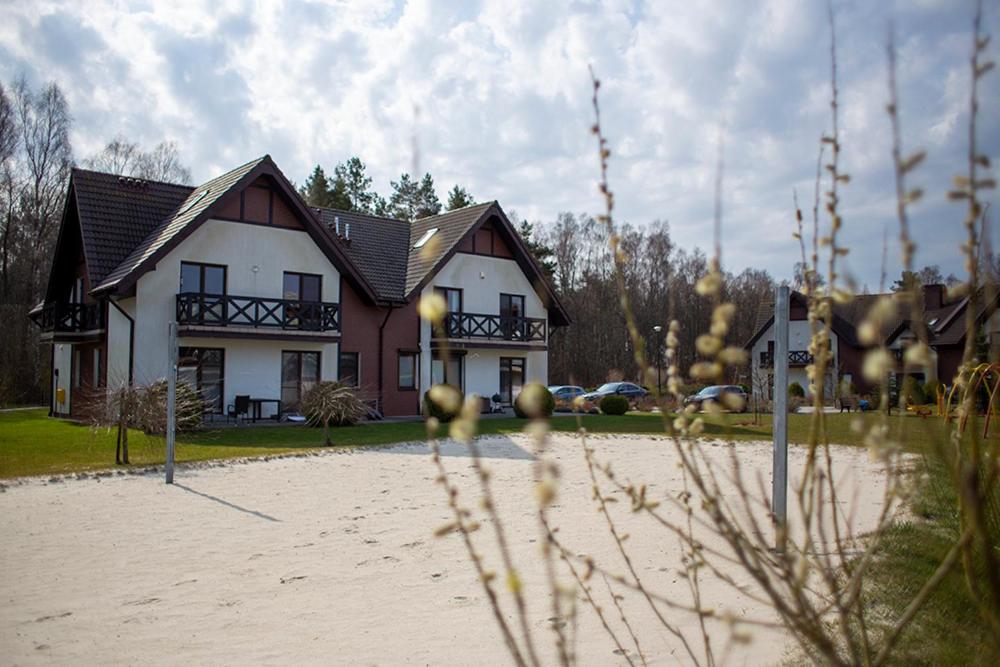 a house with a volleyball court in front of a house at Apartament Korab in Żarnowska
