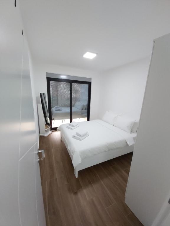 Postel nebo postele na pokoji v ubytování Apartmani Aida