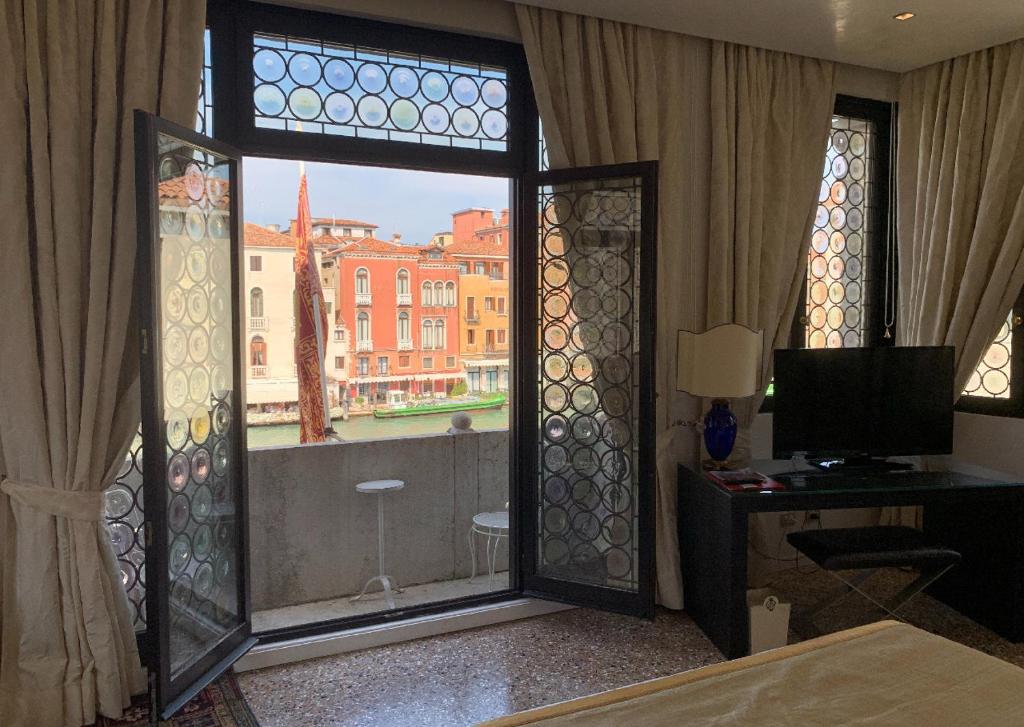 a bedroom with a large window with a view at Ca' Nigra Lagoon Resort Adults Only in Venice