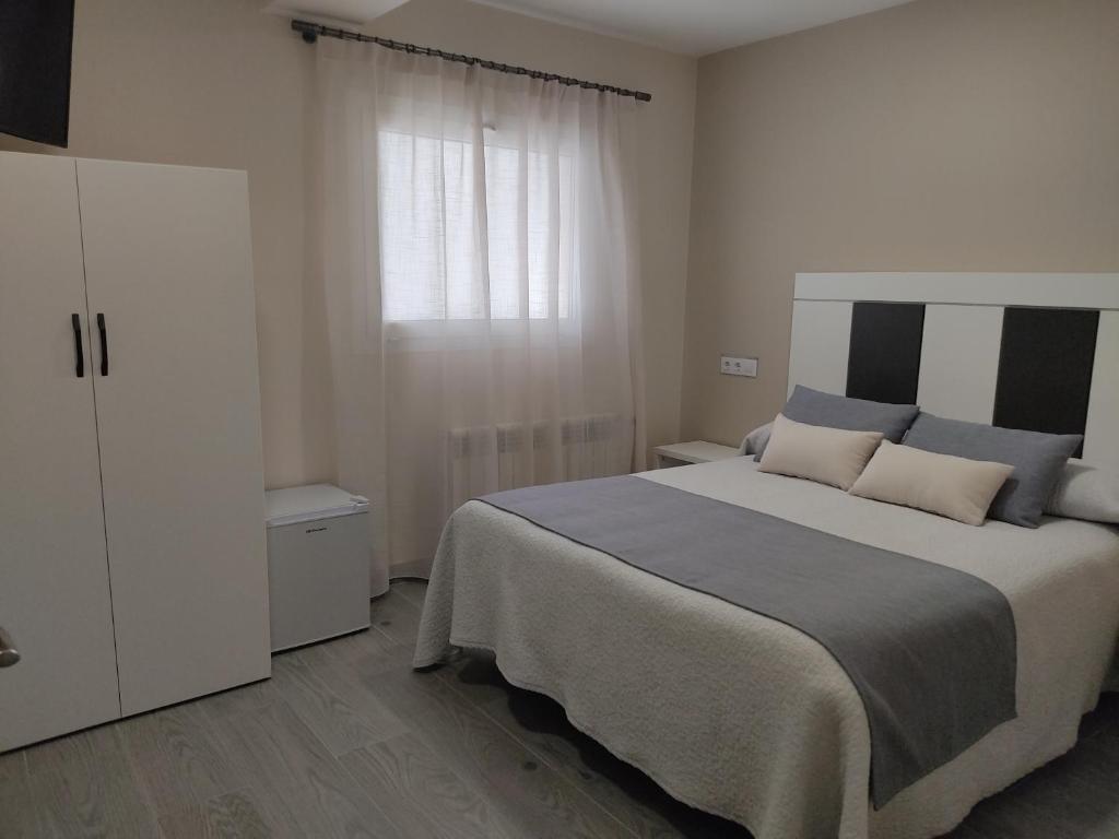 Postel nebo postele na pokoji v ubytování Hotel Querol