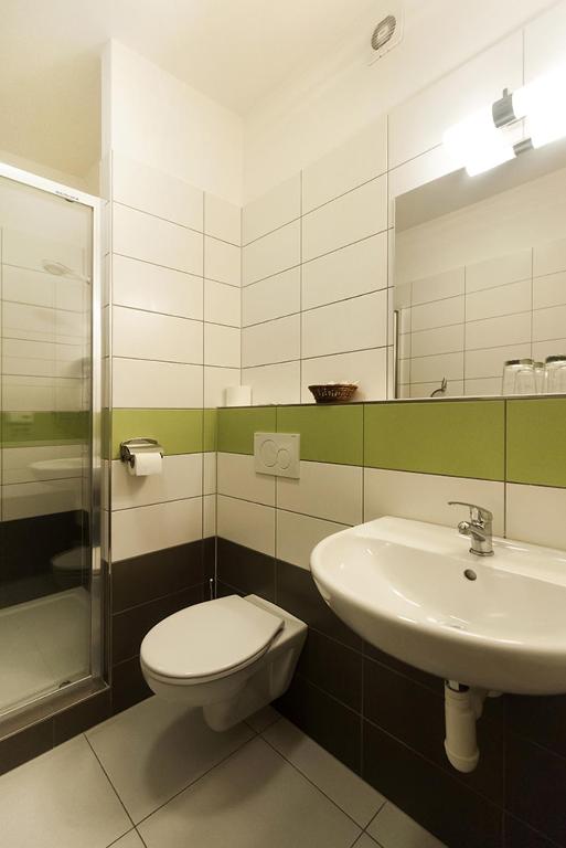 a bathroom with a toilet and a sink at Arkada Hotel in Bučovice