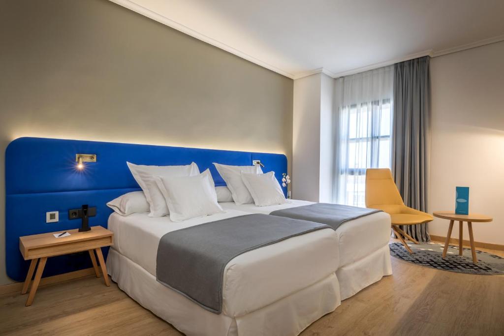 Postel nebo postele na pokoji v ubytování Barceló Cáceres V Centenario