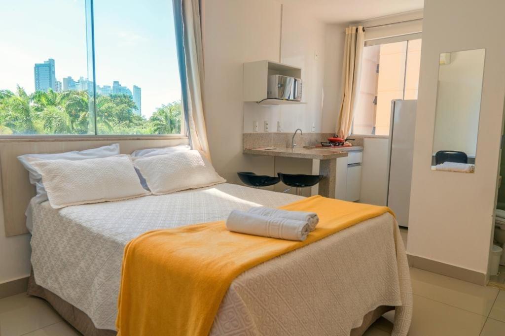 a bedroom with a bed with a towel on it at Hotel Areião in Goiânia