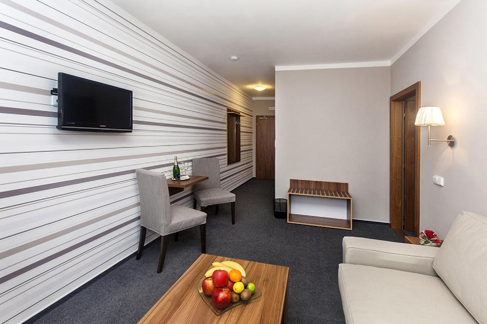 a hotel room with a wall with a flat screen tv at Arkada Hotel in Bučovice