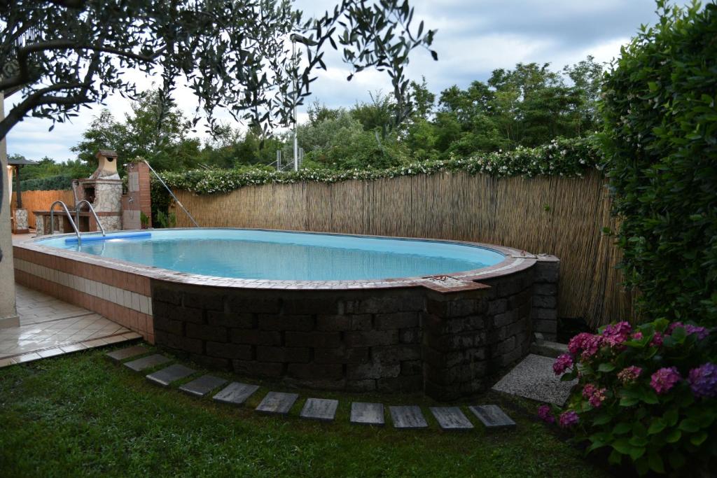 a swimming pool in a backyard with a fence at Le 2 Perle 2.0 in Peschiera del Garda