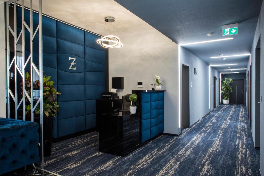 un pasillo de oficina con paredes azules y un pasillo en Z Rooms Boutique, en Zalaegerszeg