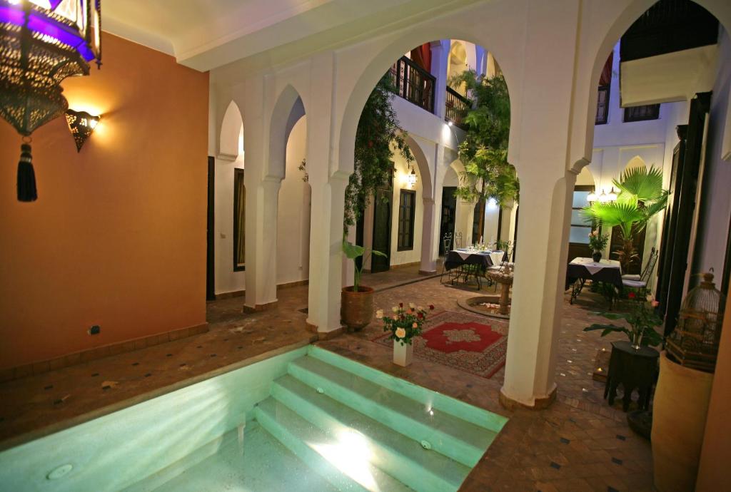a pool in the middle of a house at Riad Alwane in Marrakech