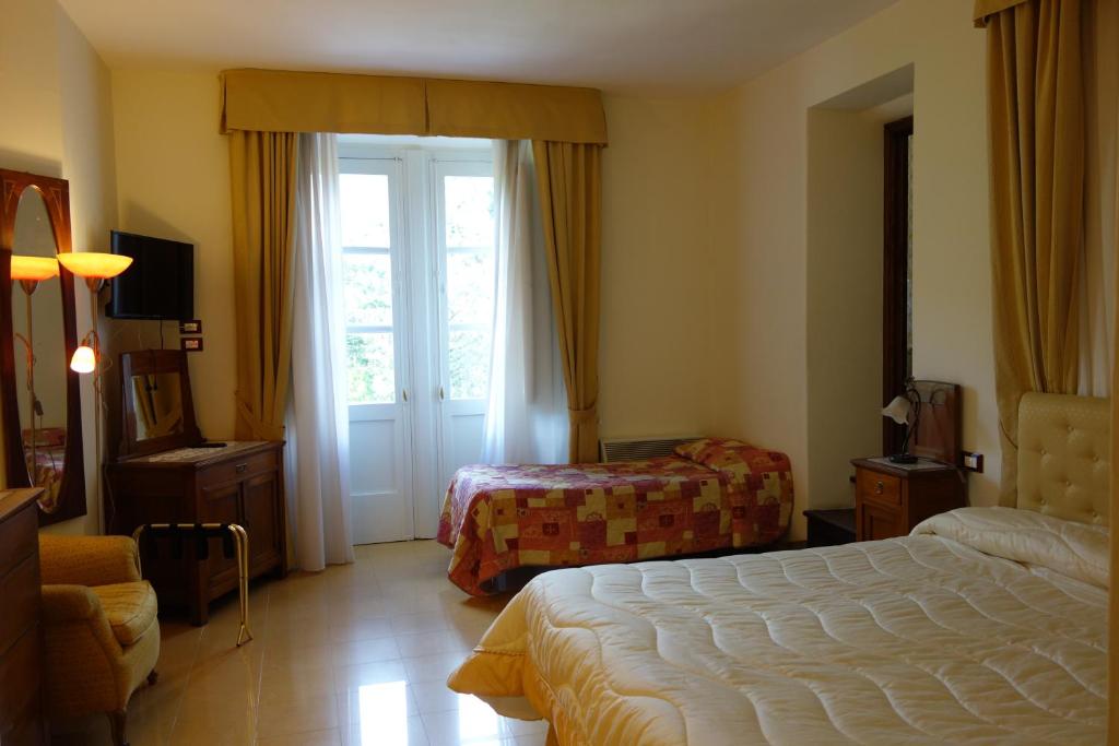 Postel nebo postele na pokoji v ubytování Hotel Roma