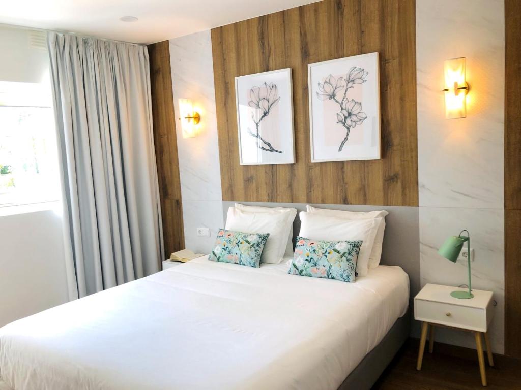 
A bed or beds in a room at Hotel Rural Solar das Arcadas
