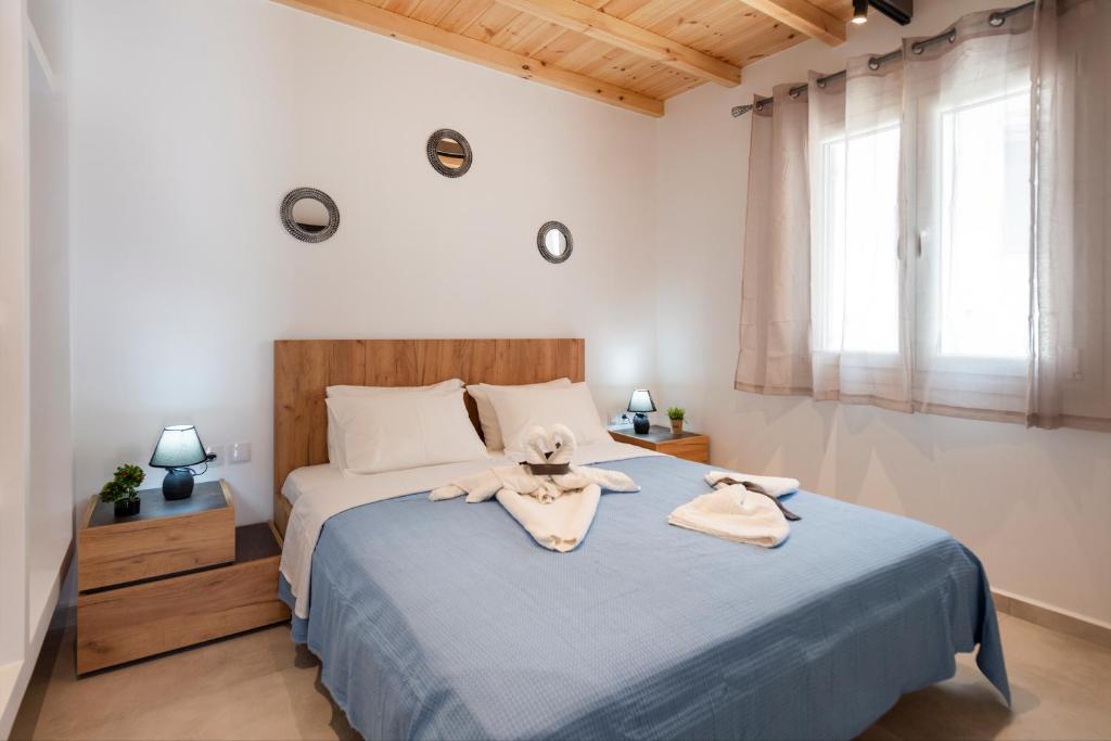 a bedroom with a bed with two towels on it at Blue View Villa #3 Luxury Sea View Private Jacuzzi in Parasporos