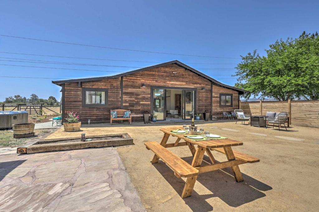a wooden cabin with a picnic table in front of it at Stunning Wine Country Gem with Hot Tub and Patio! in Sonoma
