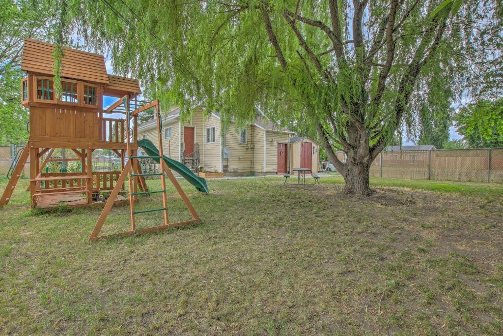 a playground with a tree and a swing at Charming Apartment Less Than 1 Mi to Logan River and Zootah! in Logan