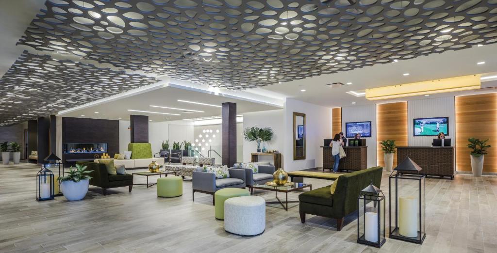 a lobby with couches and chairs in a building at The Ridge Hotel in Lake Geneva