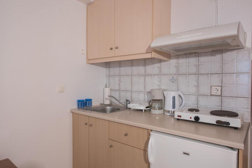 a kitchen with a sink and a counter top at Elena Studios in Athani