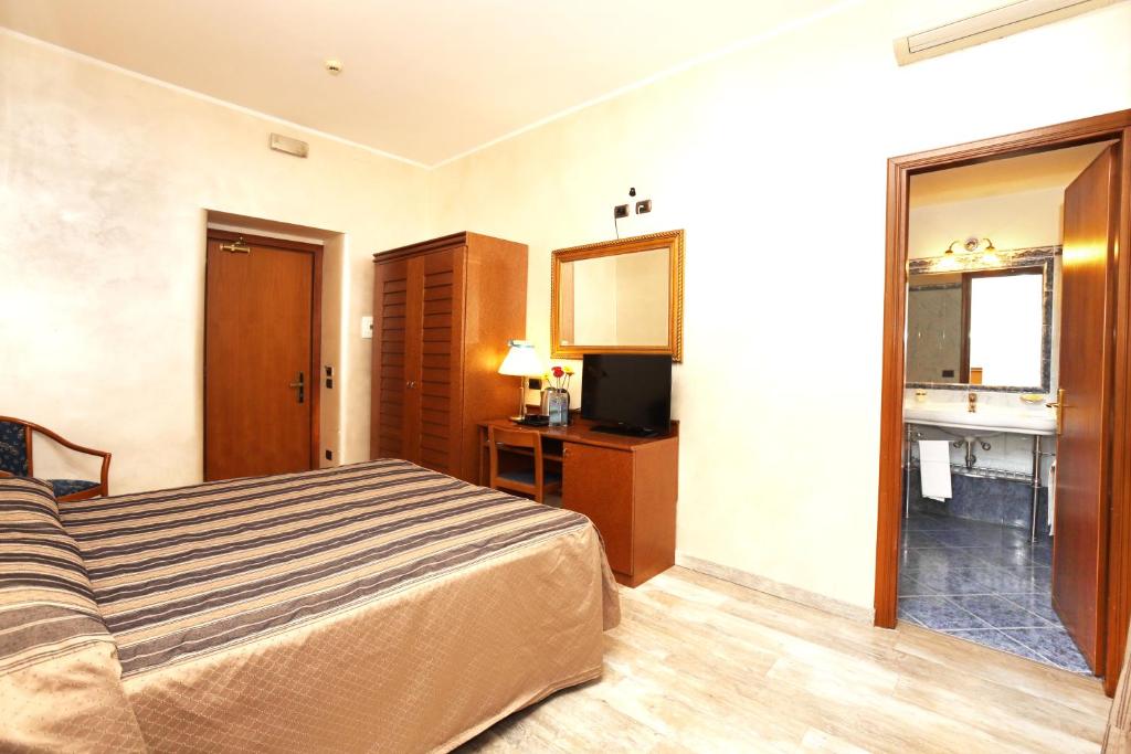 Postel nebo postele na pokoji v ubytování Hotel Rimini