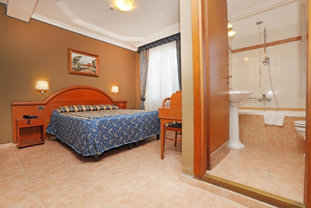 Postel nebo postele na pokoji v ubytování Hotel Rimini