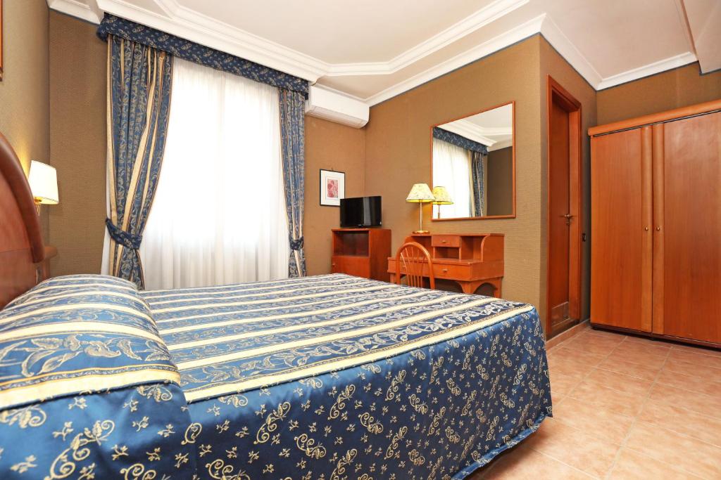 Postel nebo postele na pokoji v ubytování Hotel Rimini