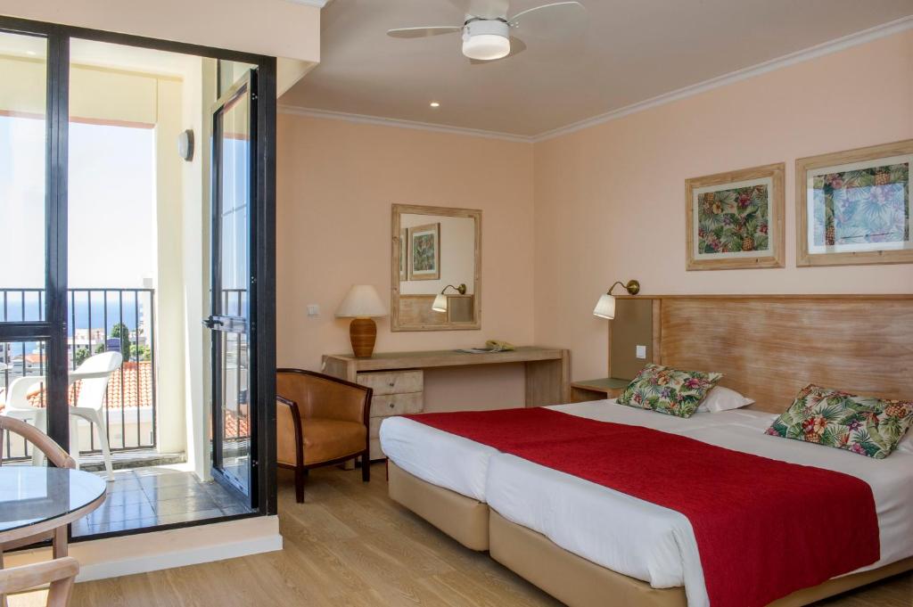 Postel nebo postele na pokoji v ubytování Buganvilia Studio Hotel