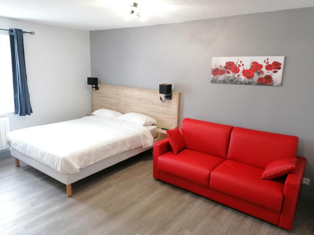 Postel nebo postele na pokoji v ubytování Hôtel Le Verger