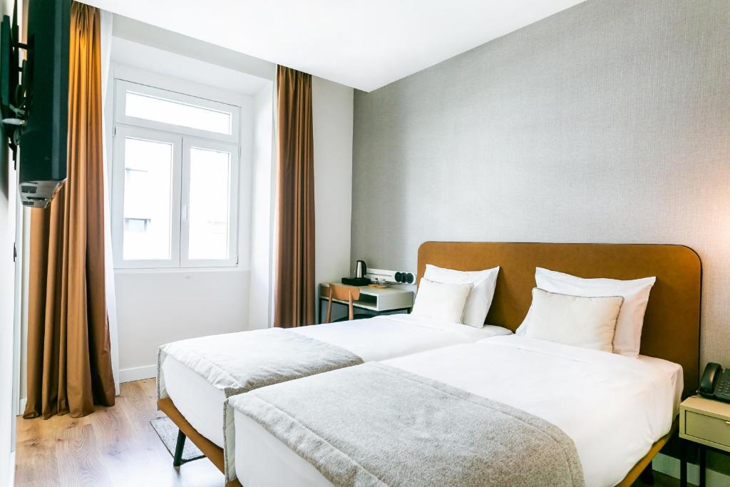 Postel nebo postele na pokoji v ubytování LX SoHo Boutique Hotel by RIDAN Hotels