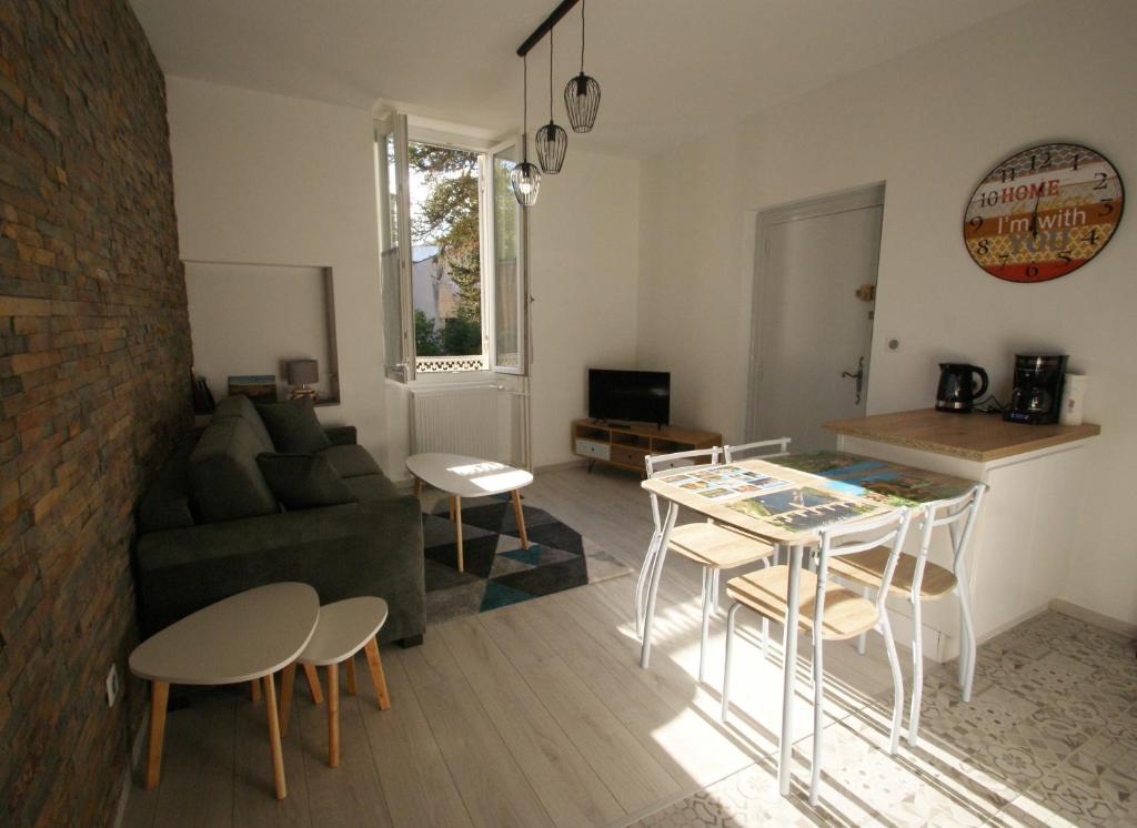 a living room with a couch and a table at LOT OF BED in Cahors