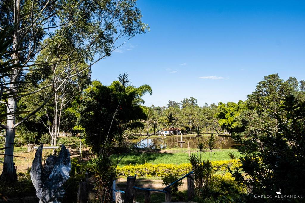 a view of a park with trees and flowers at Hotel Fazenda dos Anjos in Cambuquira