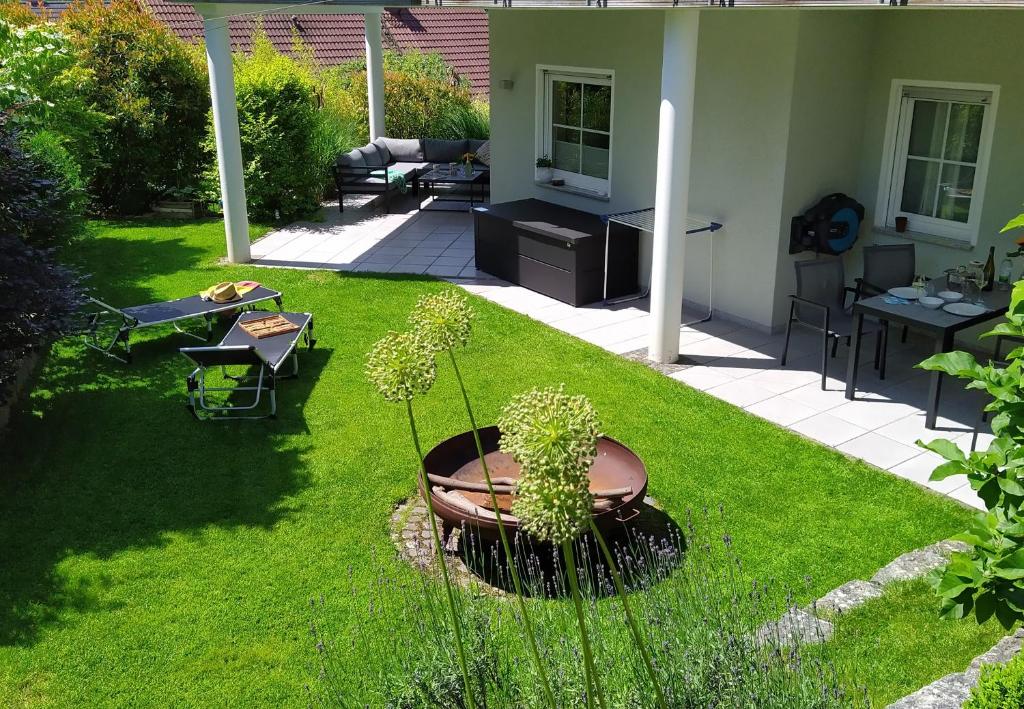 a yard with a patio with a potted plant at Entspannen im Grünen, Ferienwohnung mit eigenem Garten in Keilberg