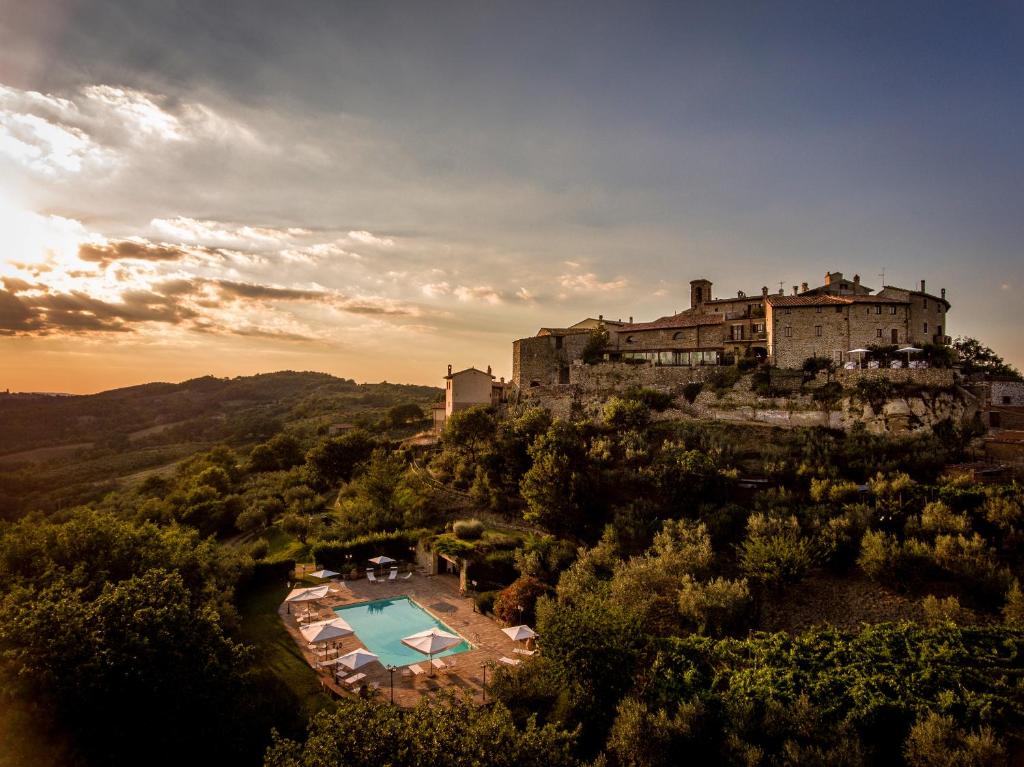 a castle on top of a hill with a pool at Aethos Saragano in Saragano