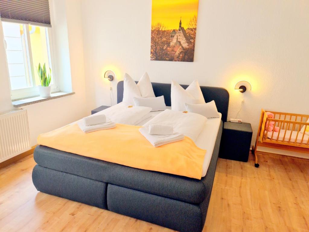 a bedroom with a large bed with white pillows at Ferienwohnung 2 Christiansdorf Freiberg in Freiberg