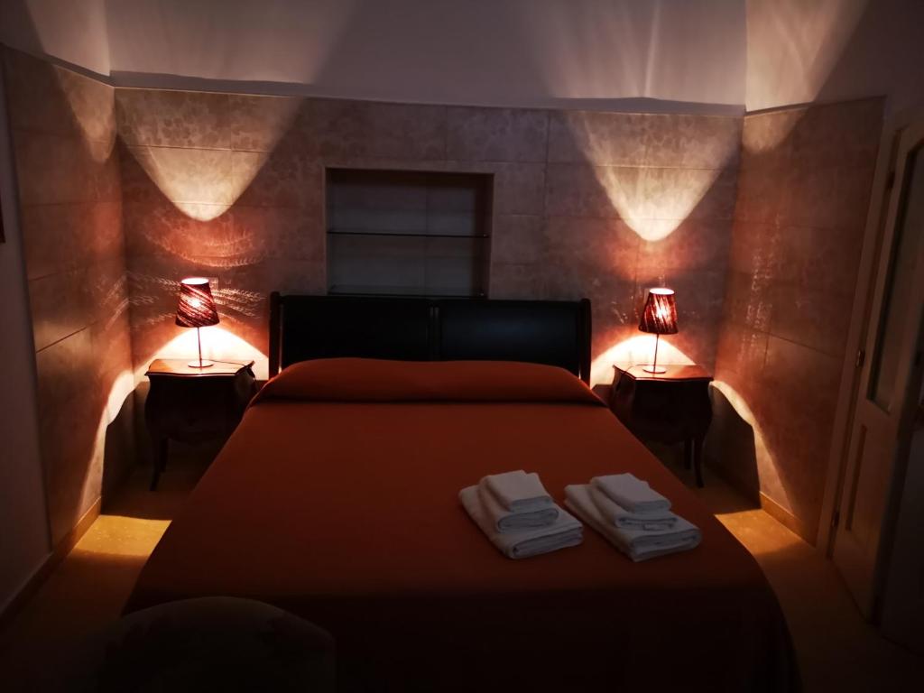 a bedroom with a bed with two lamps on it at B&B Corti Carmela in Gallipoli