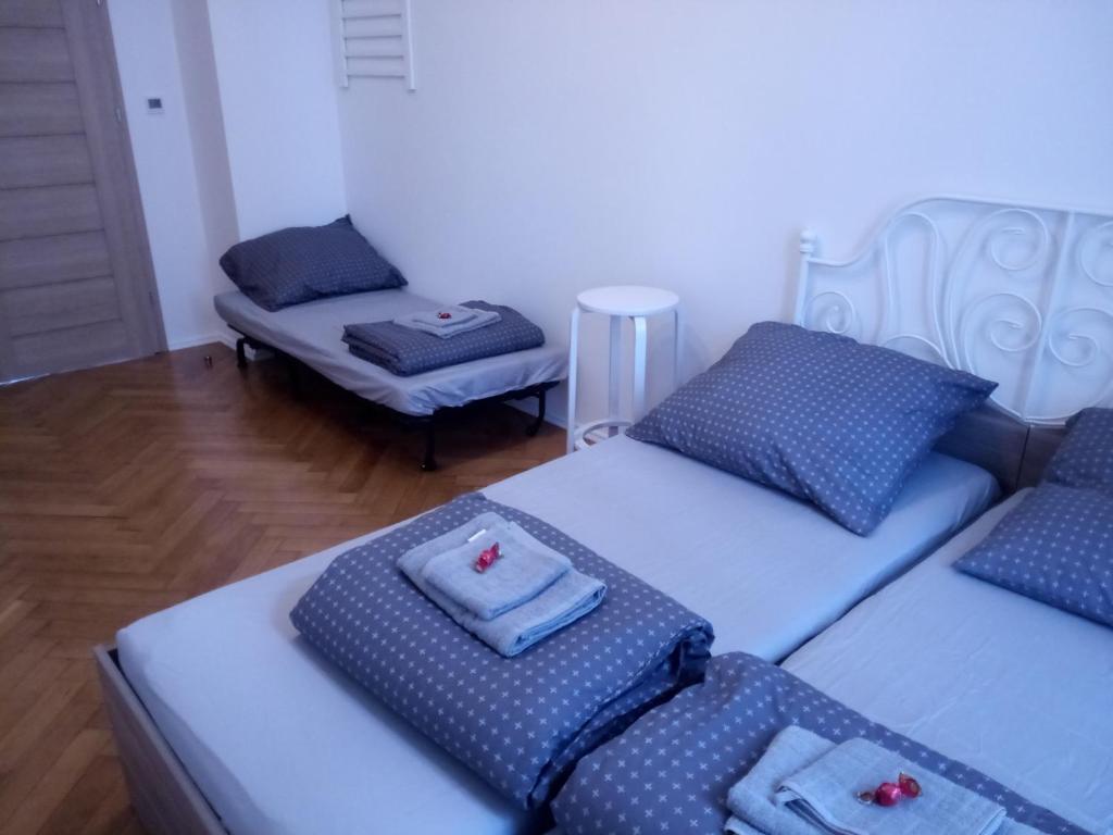 a room with two twin beds and a chair at Gallys Apartments in Prague