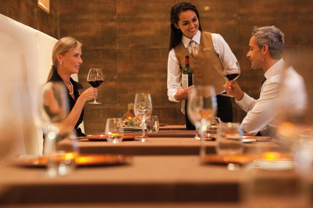 a group of people sitting around a table with wine glasses at Riu Plaza Panamá in Panama City