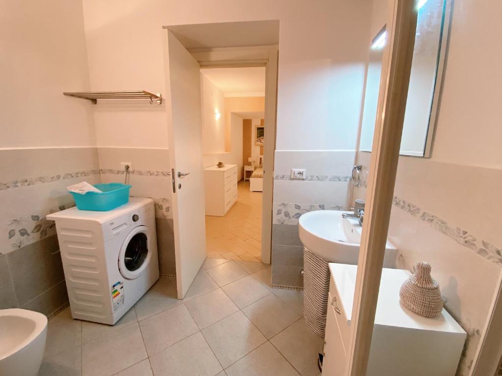 a bathroom with a washing machine and a washer and dryer at Apartment Rotone in Marciana Marina