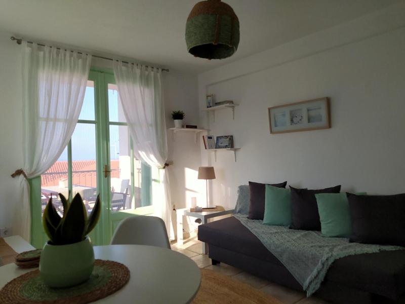ein Wohnzimmer mit einem Sofa und einem Tisch in der Unterkunft Paperboat apartment in Afytos