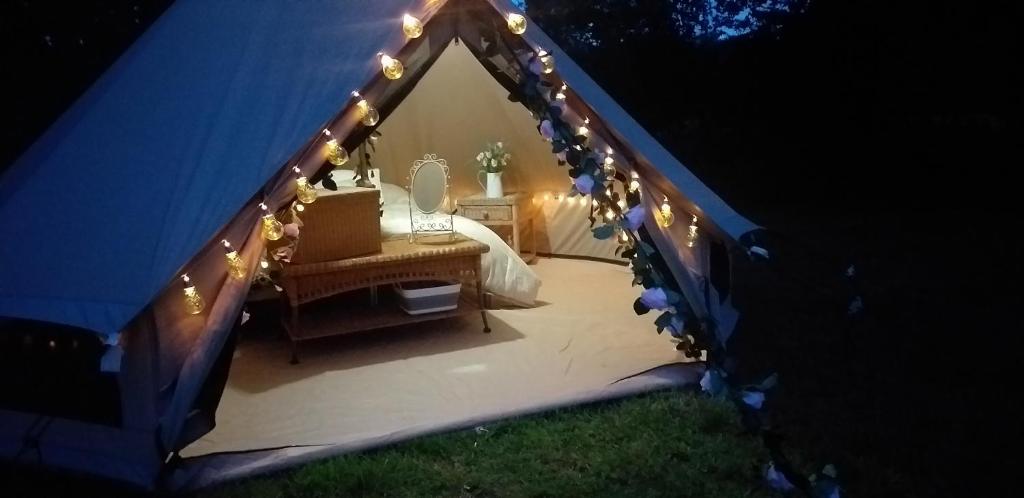 une tente avec une table et des lumières. dans l'établissement The Homestead, à West Parley