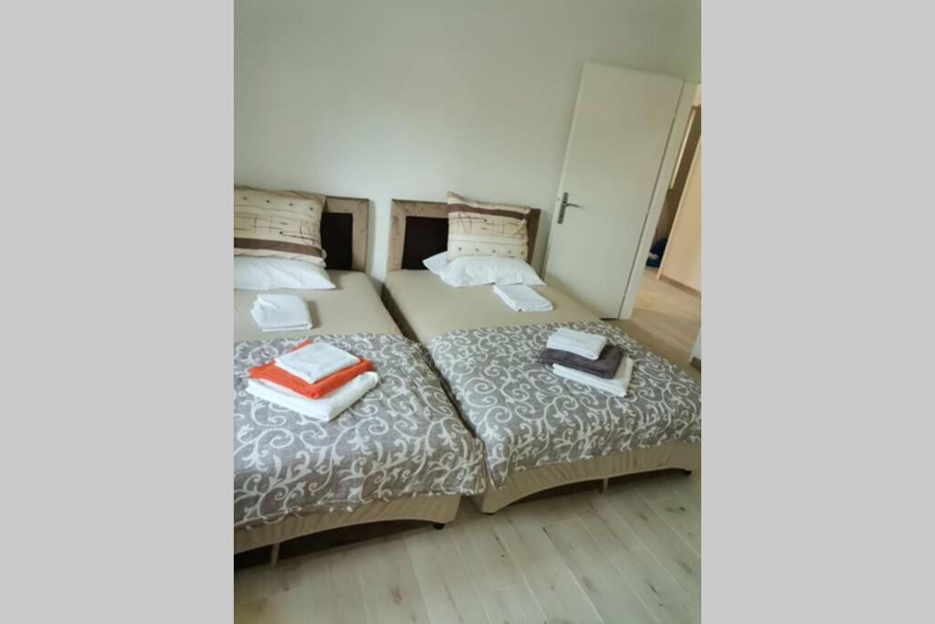 a bedroom with a bed with two books on it at Apartman Danica in Herceg-Novi