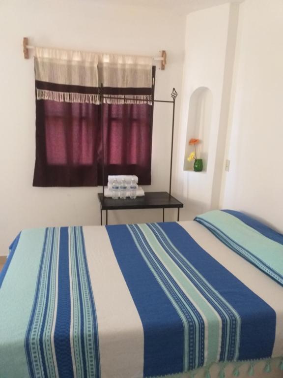 سرير أو أسرّة في غرفة في Loreto La Regional